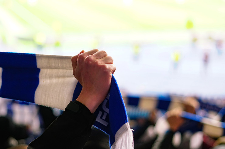 Football Fans Holding Up Blue and White Scarves