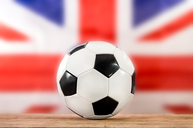 Football on Table Against UK Flag