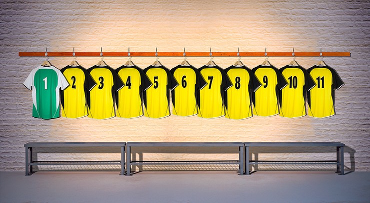 Yellow and Green Football Shirts Hanging on Pegs